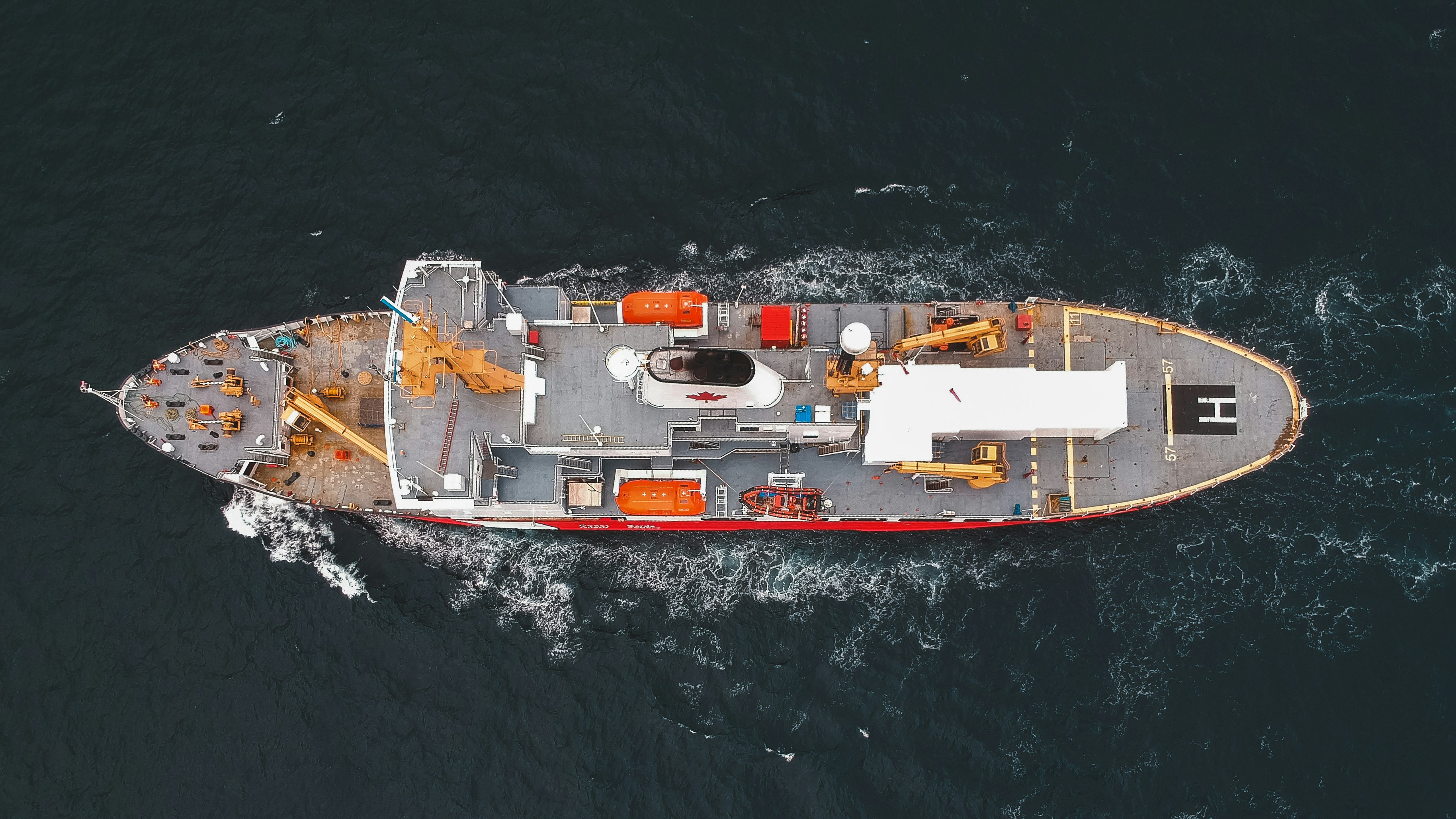 white and red boat on body of water during daytime